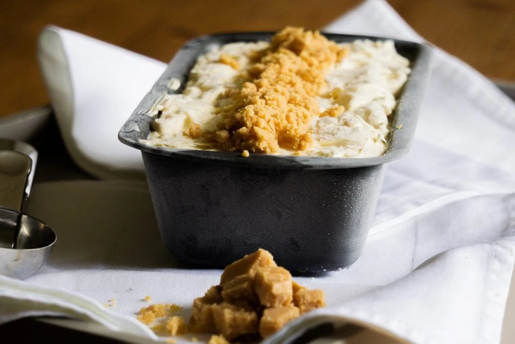 Tablet Ice Cream Recipe in a tin with scoop and tablet on the side
