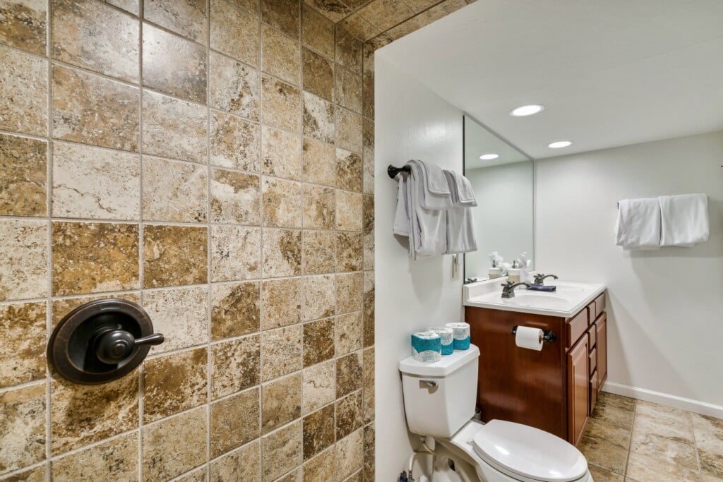 Lower-level bathroom with a dual vanity for extra convenience.