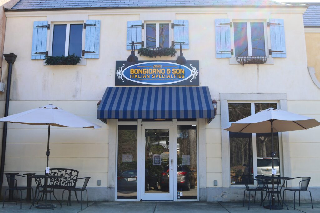 A charming storefront with a striped blue awning and cafe tables. Bongiorno expands on its Lafayette Village location to bring Italian specialties to Raleigh