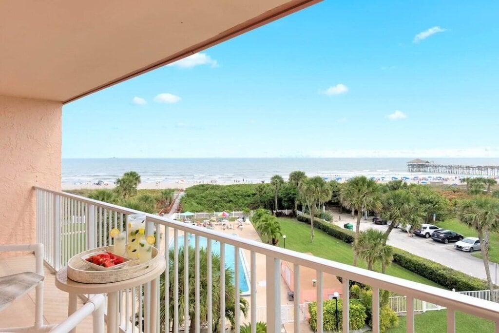 Cocoa Beach penthouse vacation home with ocean view, pool, and patio seating.
