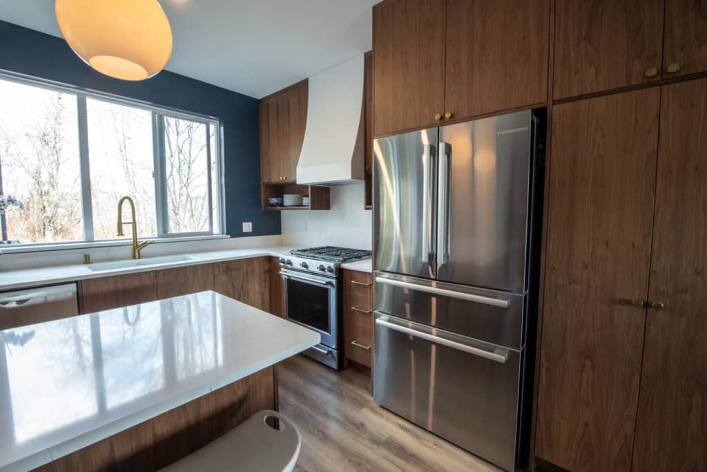 Floor-to-ceiling pantry with roll-out shelves maximize storage efficiency while maintaining a clean, cohesive look.