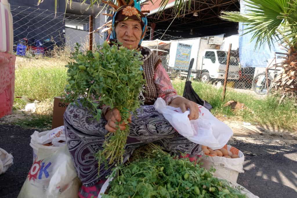 Turkey's Top Destinations for Food Lovers 3 Woman selling fresh herbs in a Food Market