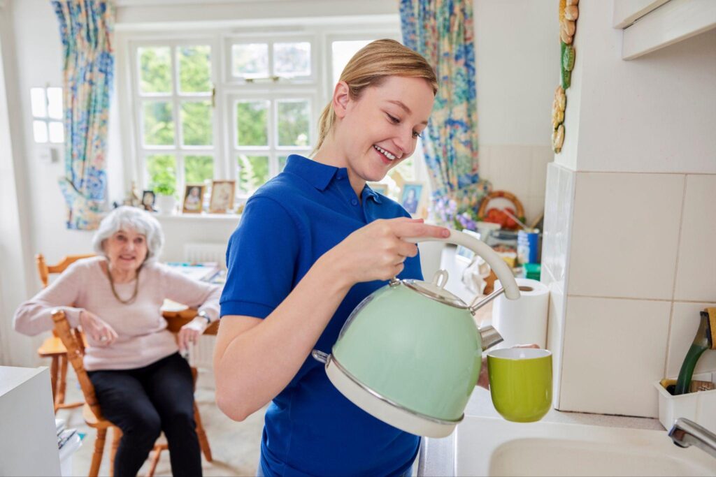caregiver teaching elder how to use electric kettle