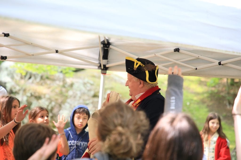 Presenter Dr. Larry Maxwell with a group of school children, 2023