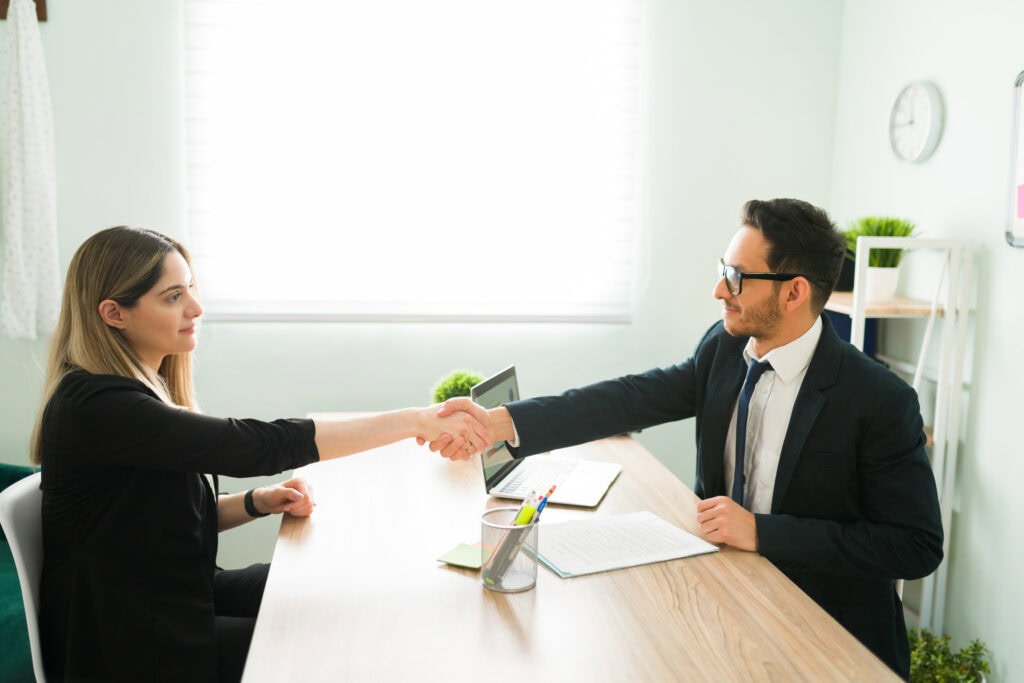Side view of a latin boss making a business deal with a colleague