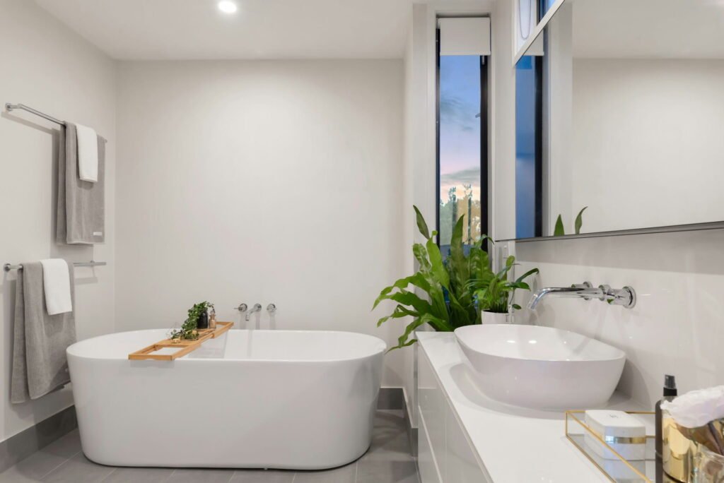 Freestanding white bathtub with vessel sink, finished bathroom renovation result