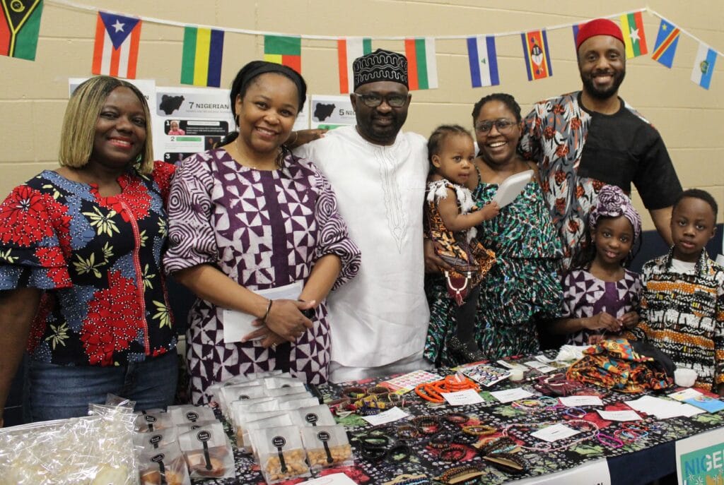 A family at a table selling their cultural items | Bishop Hamilton Montessori School in Ottawa
