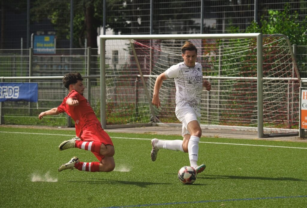 Two soccer players in action during an outdoor match, showing skill and competition.