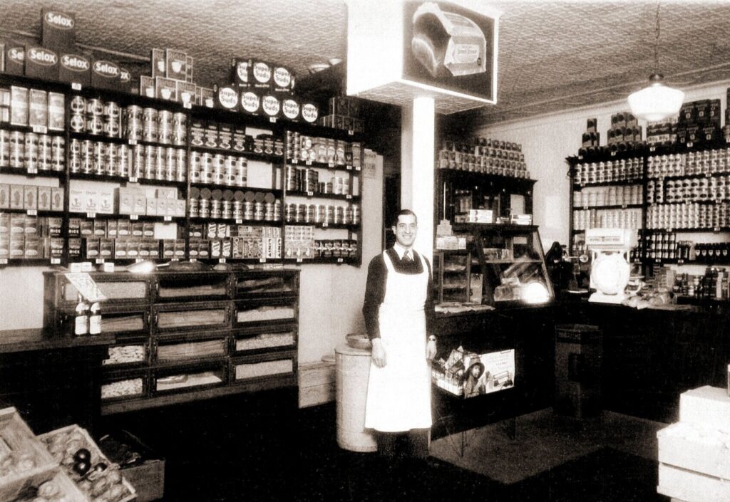 A black and white photo of an old Italian grocery store