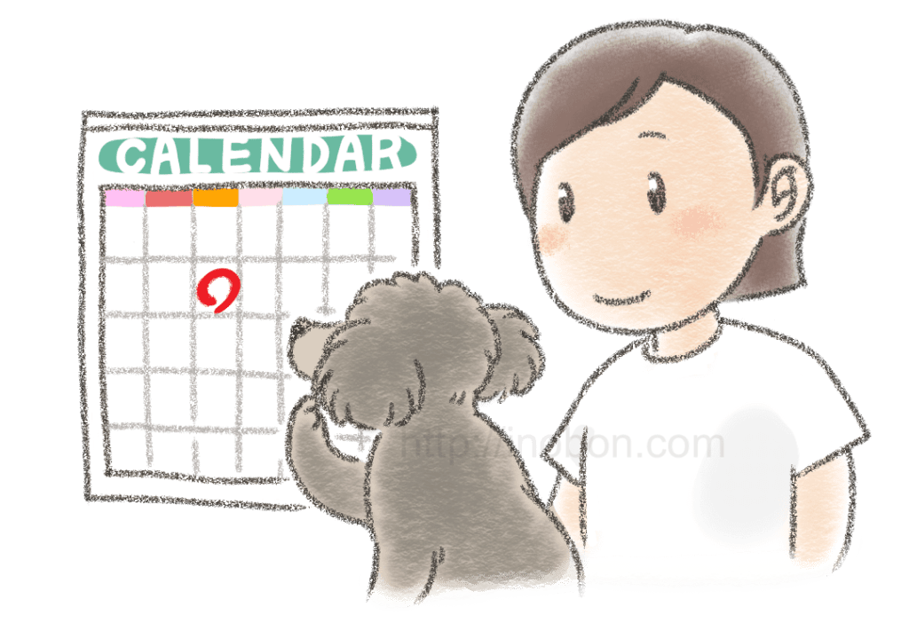 犬と飼い主の女性がカレンダーを見ている