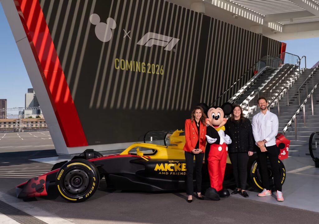 Disney Formula 1 Topolino Romain Grosjean Emily Prazer (Chief Commercial Officer di Formula 1), Tasia Filippatos (President di Disney Consumer Products) insieme a Romain Grosjean (ex pilota F1) e Topolino