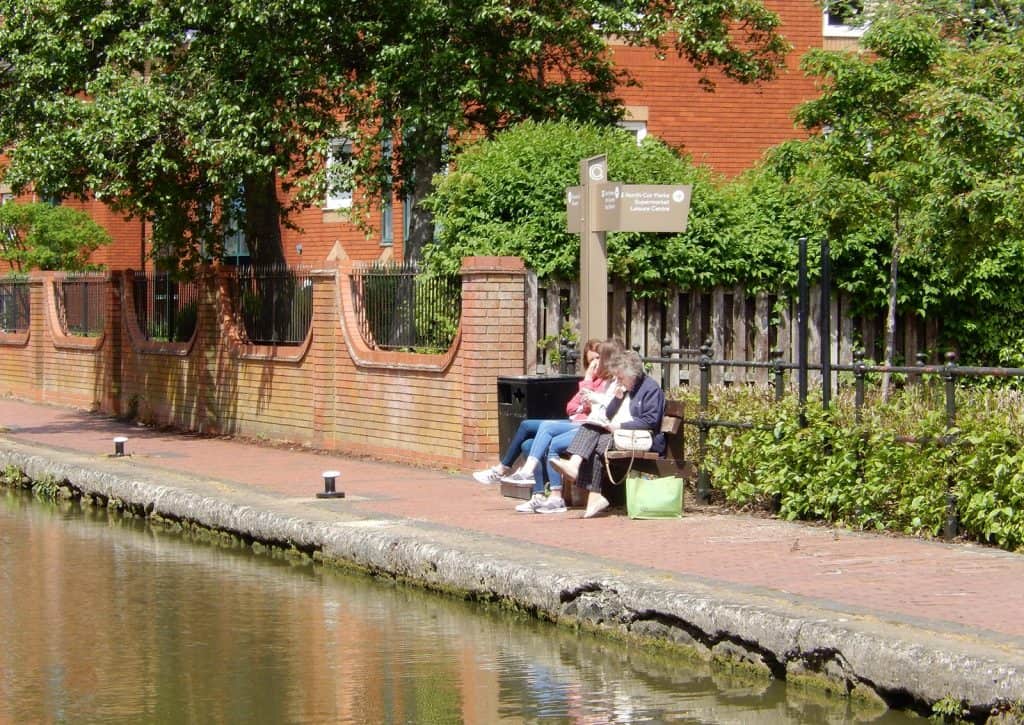 Long view of fingerpost sign for Castle Quay along the canal