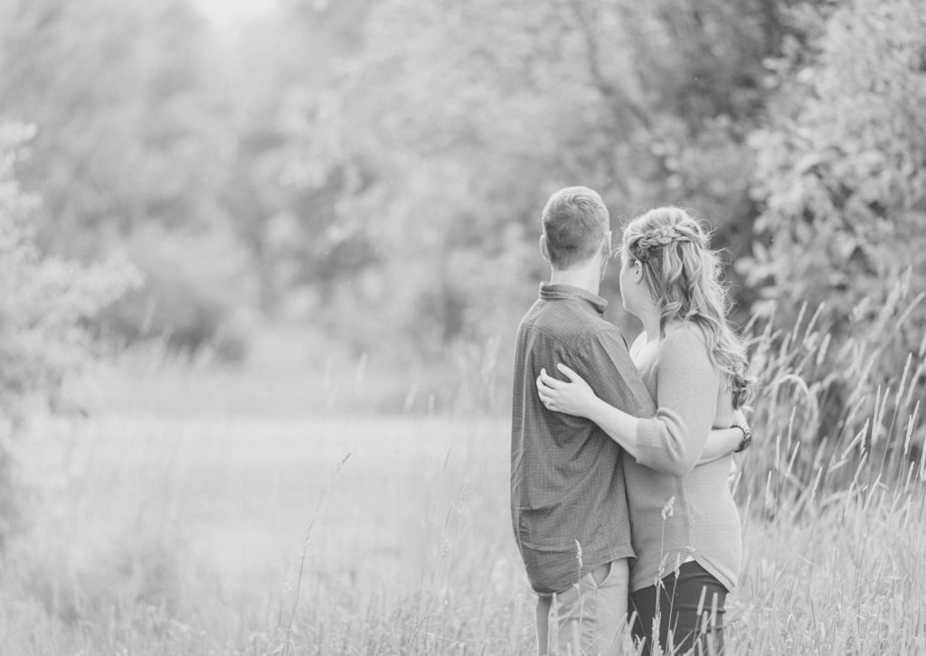 Poses during Engagement Session Sunset - Natural Posing for Photo Session - Couples Photo Session Fun - Fun on the Farm - Farm Engagement Session - Blue and Brown Engagement Session Inspiration - Natural Engagement Session Posing - Ideas for what to wear for Engagement Photography, Modern Engagement Session Inspiration Wardrobe Ideas. Unsure of what to wear for your engagement photos, we've got you! Romantic brown with black leggings for Summer Engagement in Almonte. Grey Loft Studio is Ottawa's Wedding and Engagement Photographer for Real couples, showcasing photos that are modern, bright, and fun.