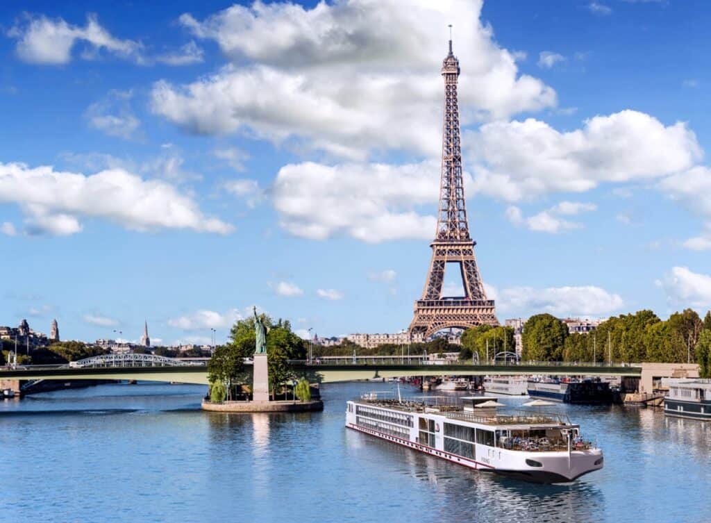 Eiffel Tower view with Seine River cruise boat in Paris, France.