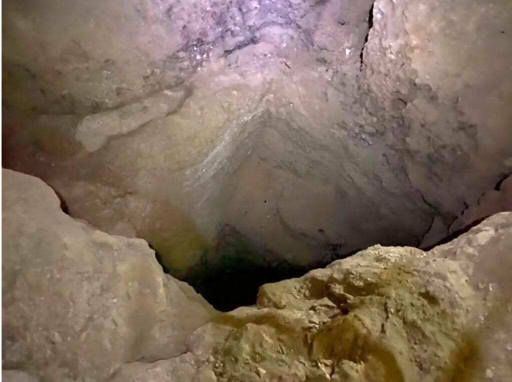 Archaeologists exploring a newly discovered passageway inside the Great Pyramid of Giza, uncovering hidden chambers.
