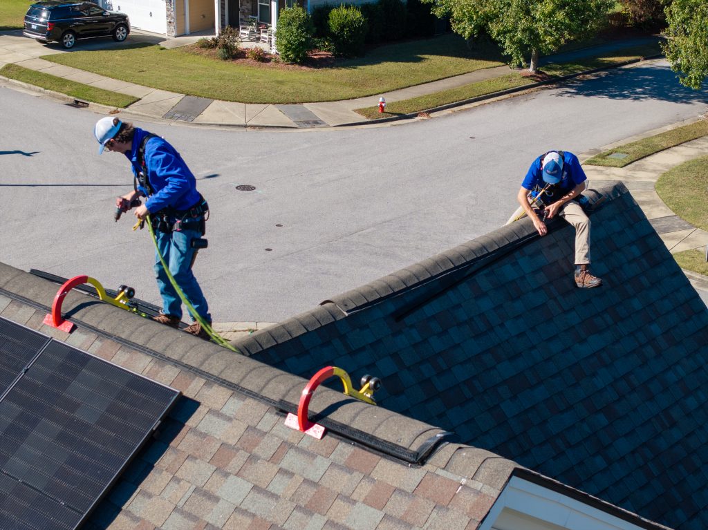 Technicians doing a wildlife removal and prevention job