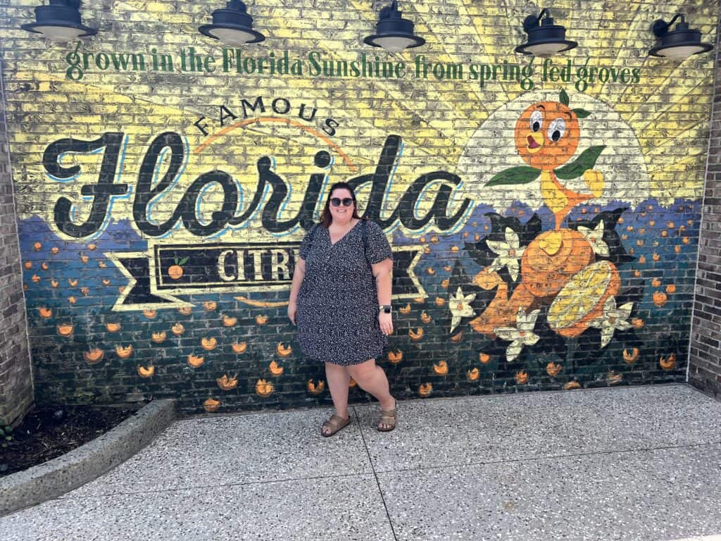 Bright, colorful mural at Florida Citrus farm featuring a cheerful orange character. Perfect for vacation photos and citrus-themed experiences.