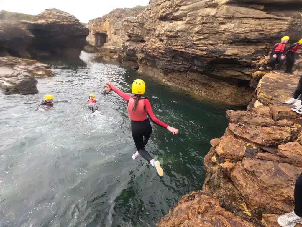 Girl Jumping from Rocks