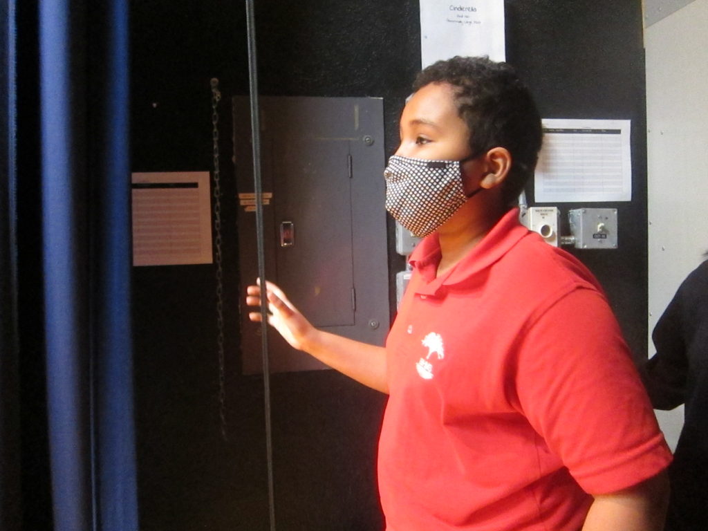 A boy with a mask looking off in the distance | Bishop Hamilton Montessori School in Ottawa