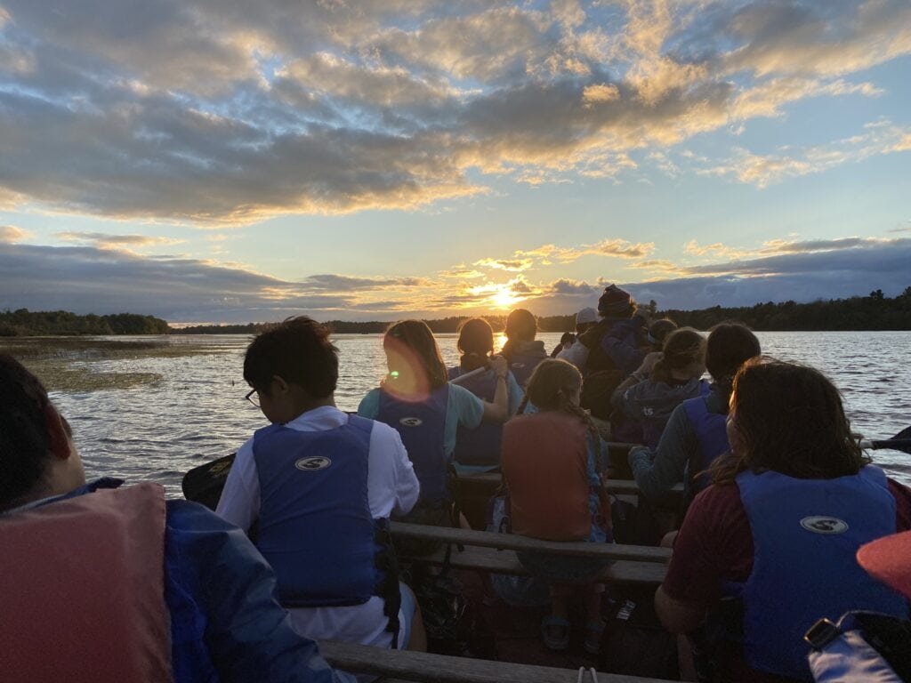 A group of students on a canoe rowing out onto the lake | Bishop Hamilton Montessori School in Ottawa