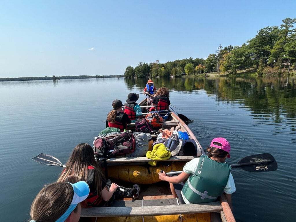 A group of students on a canoe rowing out on a lake | Bishop Hamilton Montessori School in Ottawa