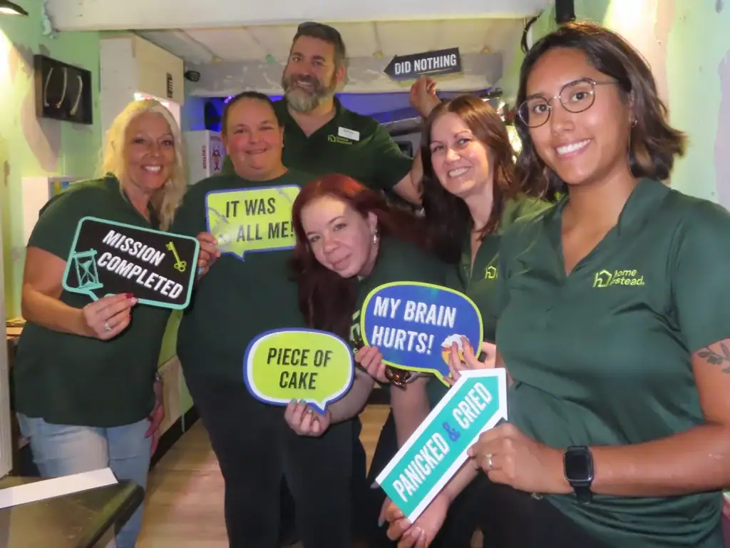 Corporate team celebrating a successful escape room challenge together
