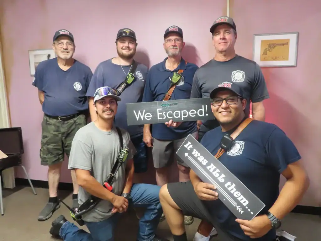 Corporate team celebrating a successful escape room challenge together