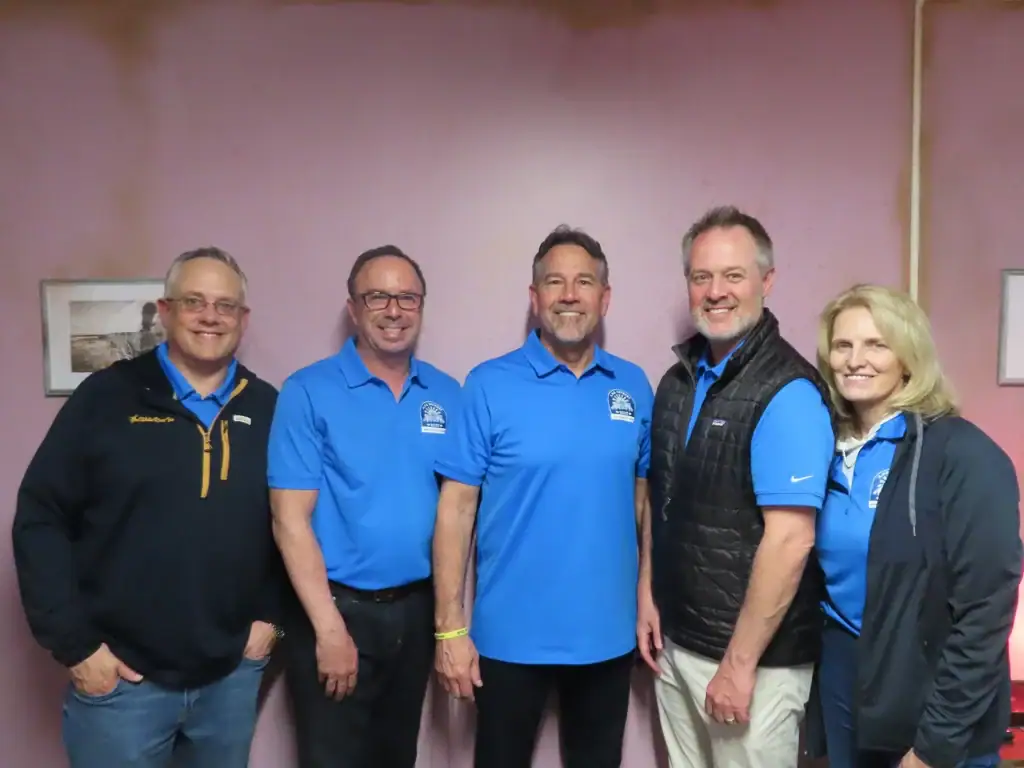 Corporate team celebrating a successful escape room challenge together