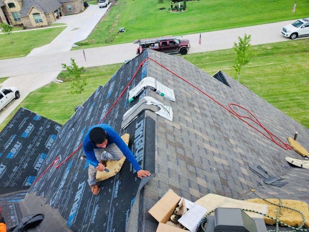 JDCC Roofing crew installing underlayment and asphalt shingles during a roof replacement in Weatherford, TX