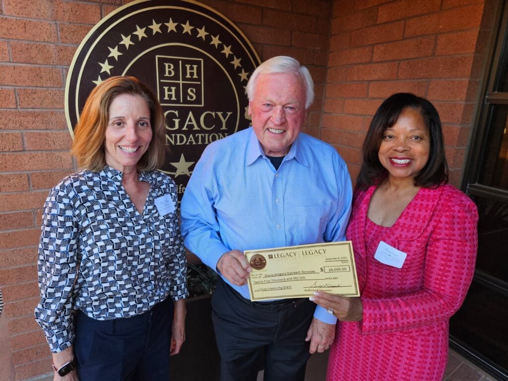 BHHS Legacy Foundation CEO Gerry Wissink presents a $25,000 grant check to Diana Gregory of Diana Gregory Outreach Services in support of hunger-relief programs.
