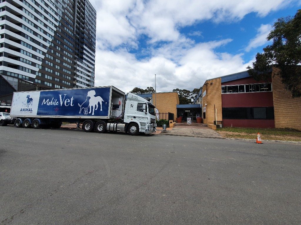 mobile vet parked in front of a building