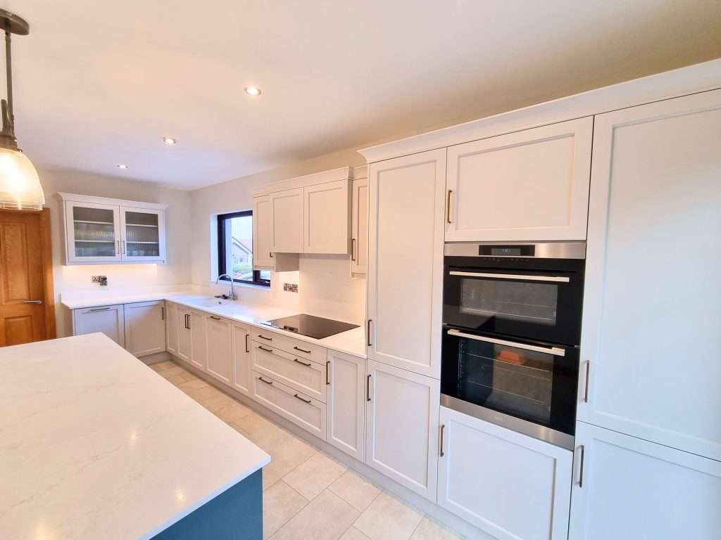 Modern white kitchen with sleek cabinetry and appliances