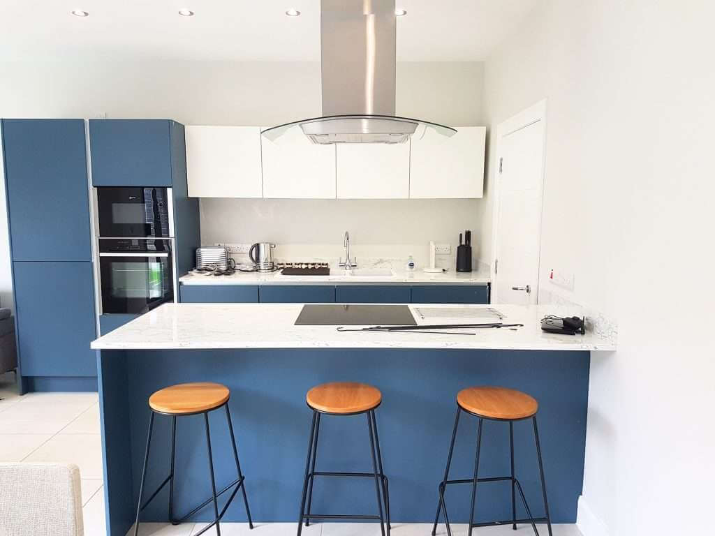 Modern kitchen with blue cabinets and stools