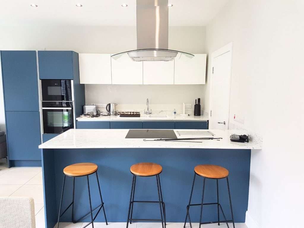 Modern kitchen with blue island and stools