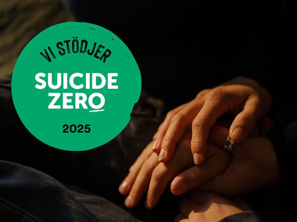 Två händer som håller varandra i en stödjande gest i förgrunden, med en grön cirkel i bilden där texten 'Vi stödjer Suicide Zero 2025'.