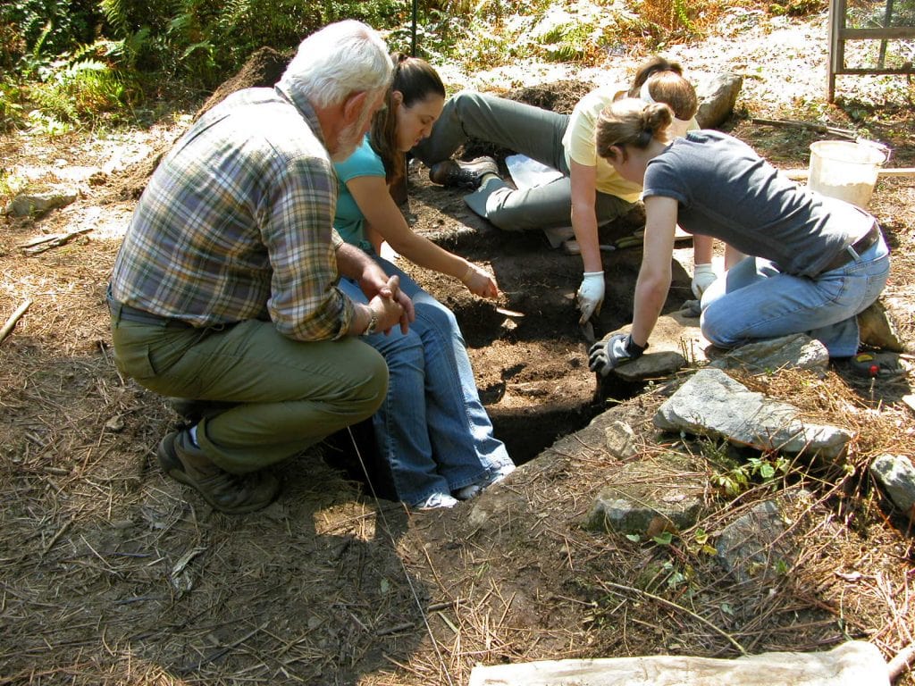 Local historian Dan Cruson with archaeology students, excavating a hut