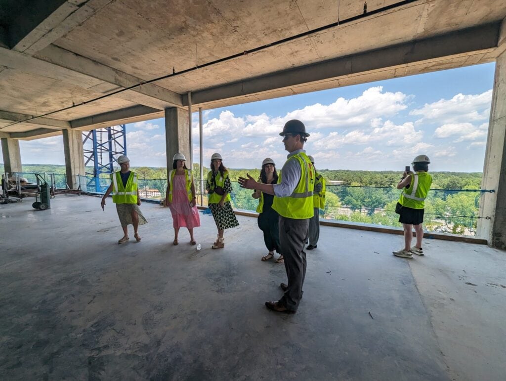 A gathering of journalists from Triangle Business Journal, Raleigh Magazine, RALToday, Wake Living, and more celebrate 1000 Social's construction milestone, bringing luxury office, retail, and event space to Raleigh