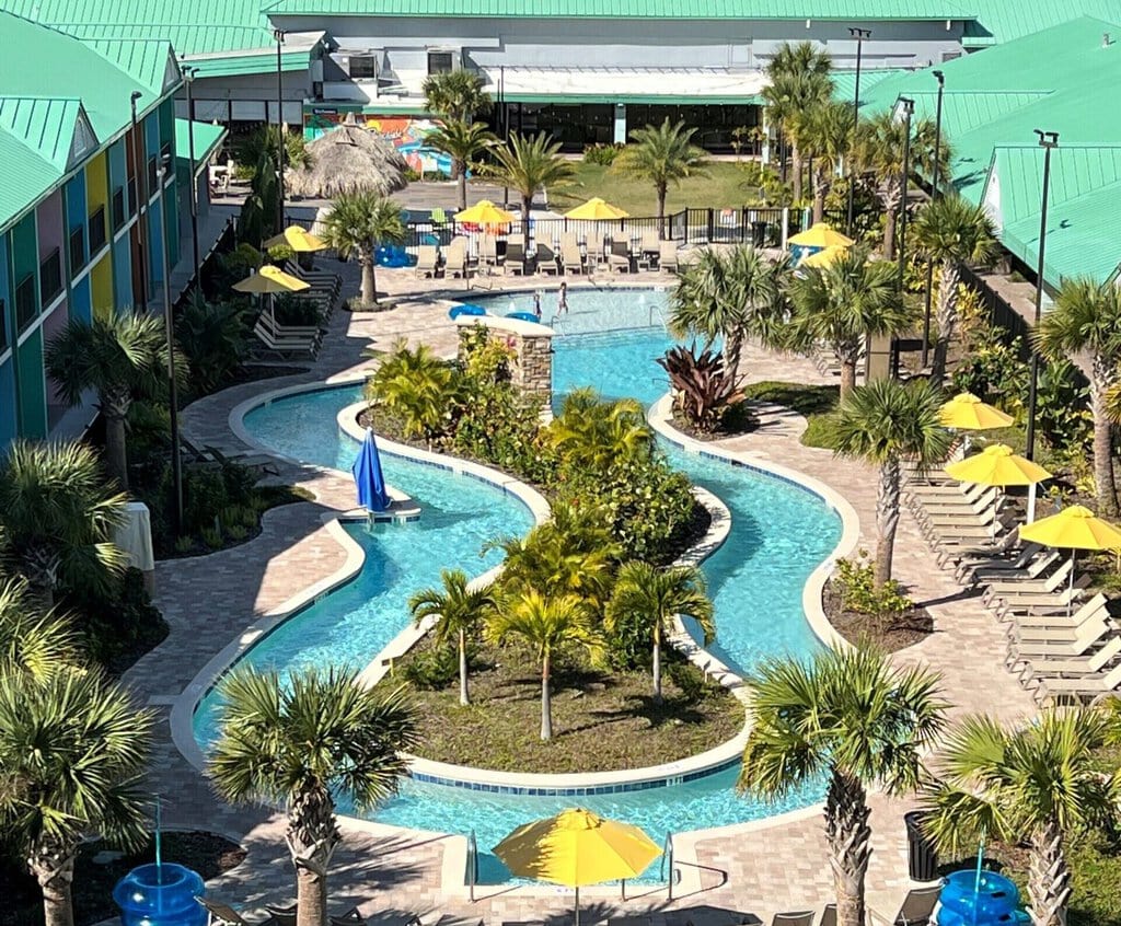 Aerial view of the lazy river pool at Beachside Hotel & Suites in Cocoa Beach, a pet friendly hotel with tropical vibes and outdoor amenities.