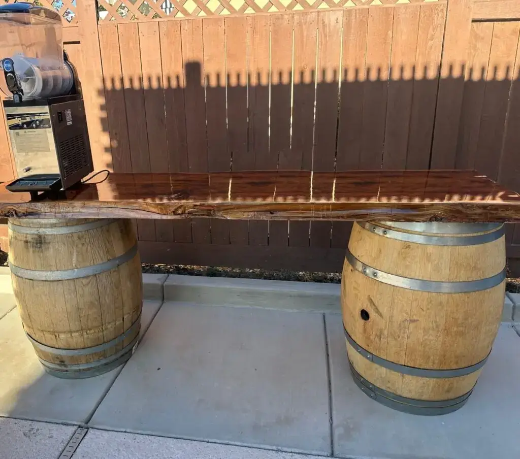 Rustic wine barrel bar with a live-edge redwood top and a slushy machine