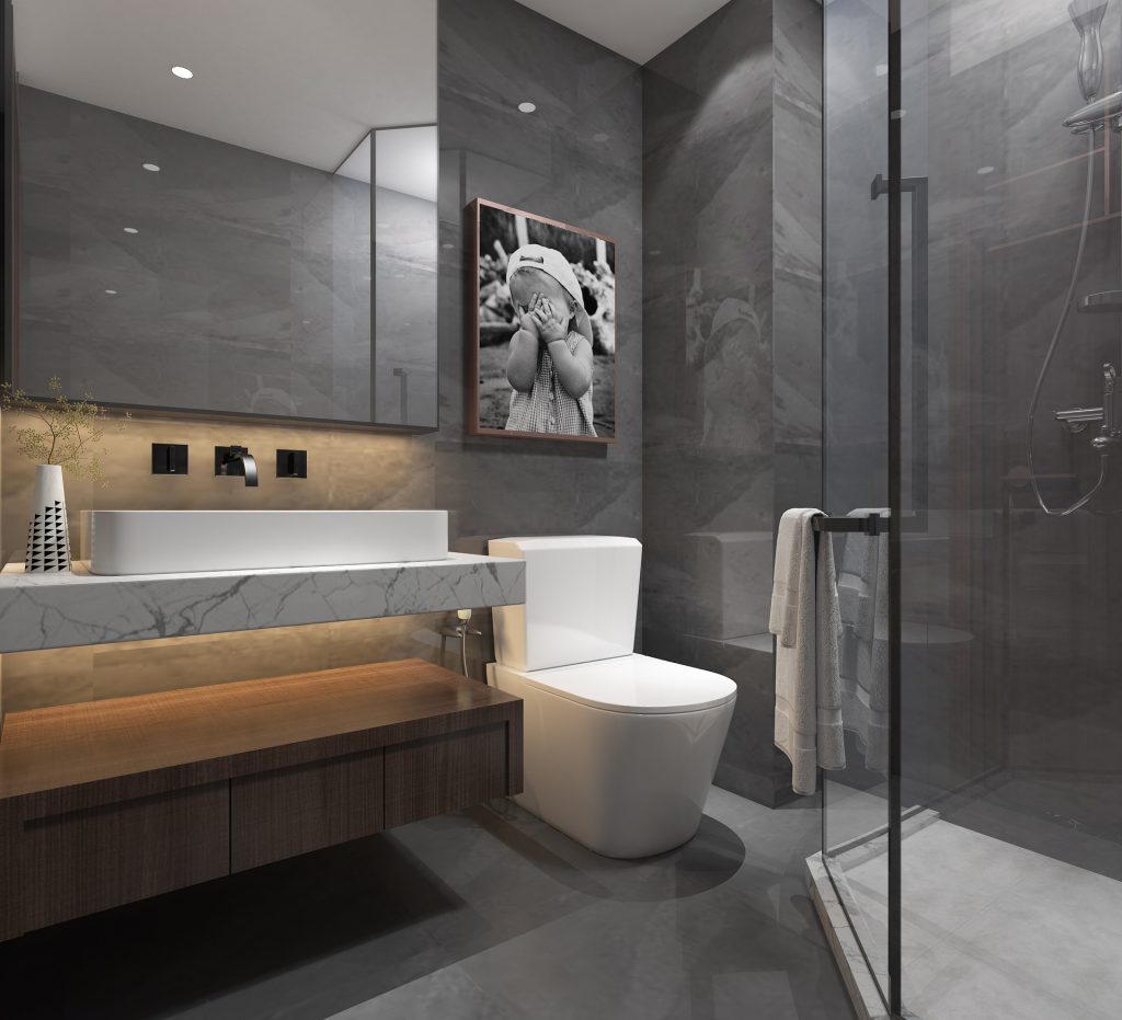 Image of bathroom with shower door open. Toilet and sink to left of image.