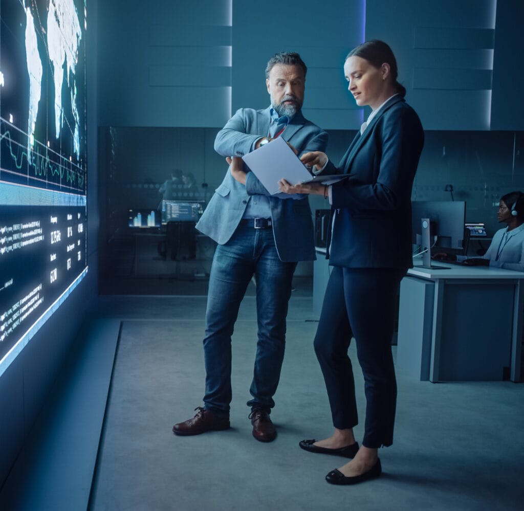 two people looking at a computer in a security center