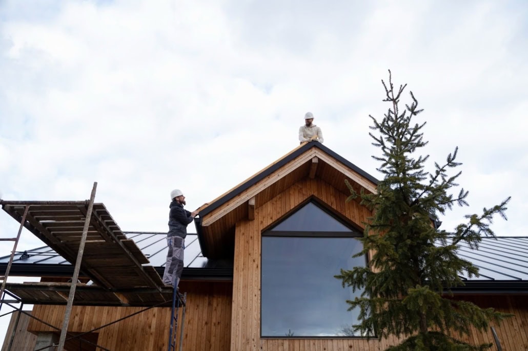 Installation of a roof by professionals on a residential building. Get a free estimate today by getting in touch with us.
