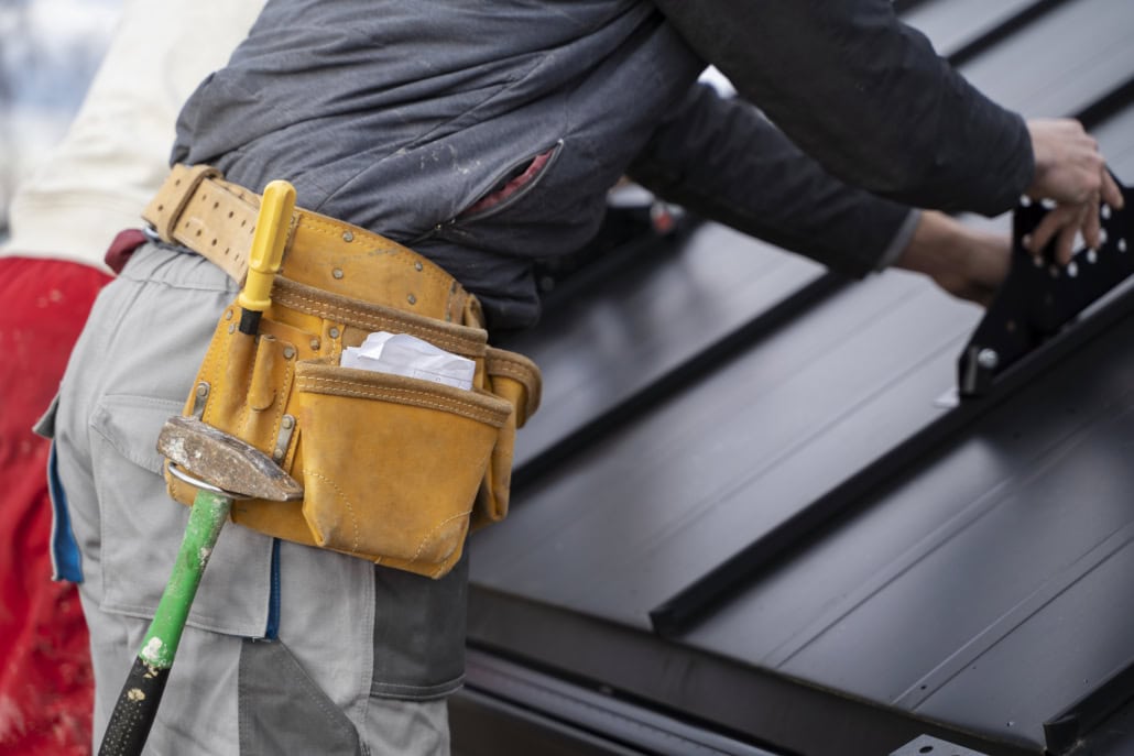 A licensed roofer working on the repair of a residential rooftop. Get your free estimate from us today.
