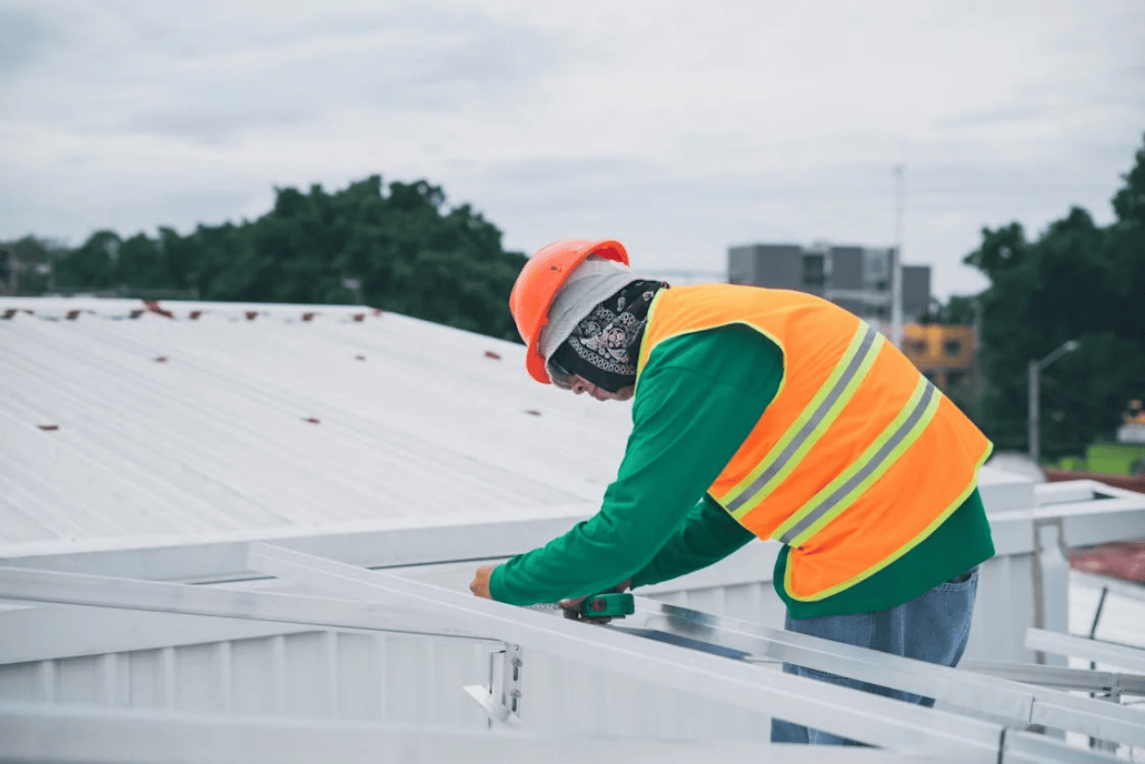 A licensed roofing contractor working on the repair of a roof. Get in touch with us today for a free estimate.
