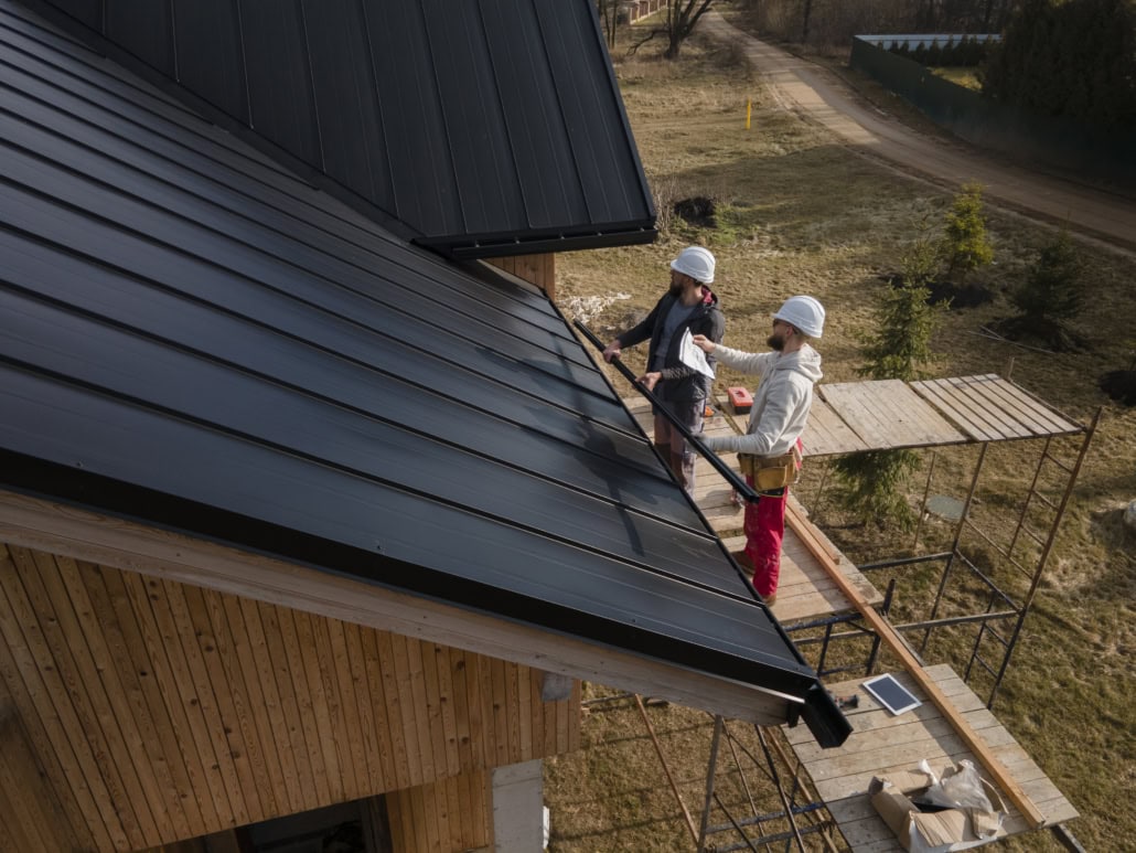 A licensed roofing contractor working on the repair of a residential rooftop. To get an estimate, get in touch with us today.