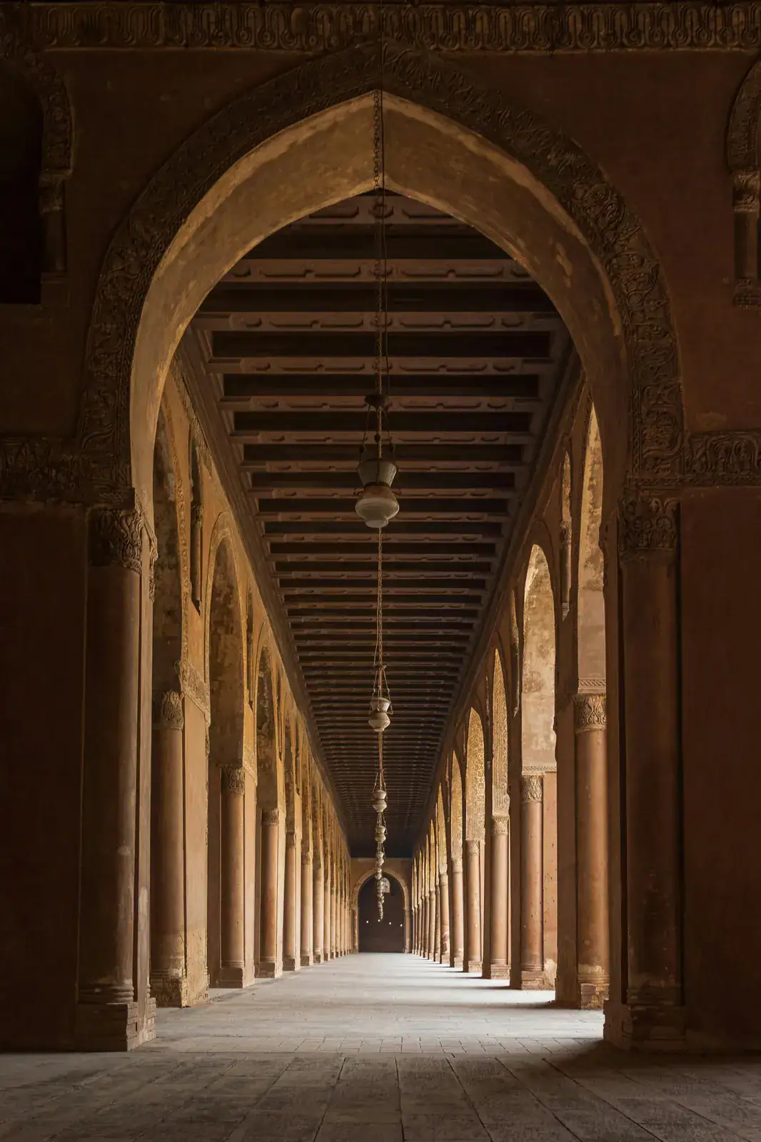 Shaded arcades and hanging lamps inside the historic mosque