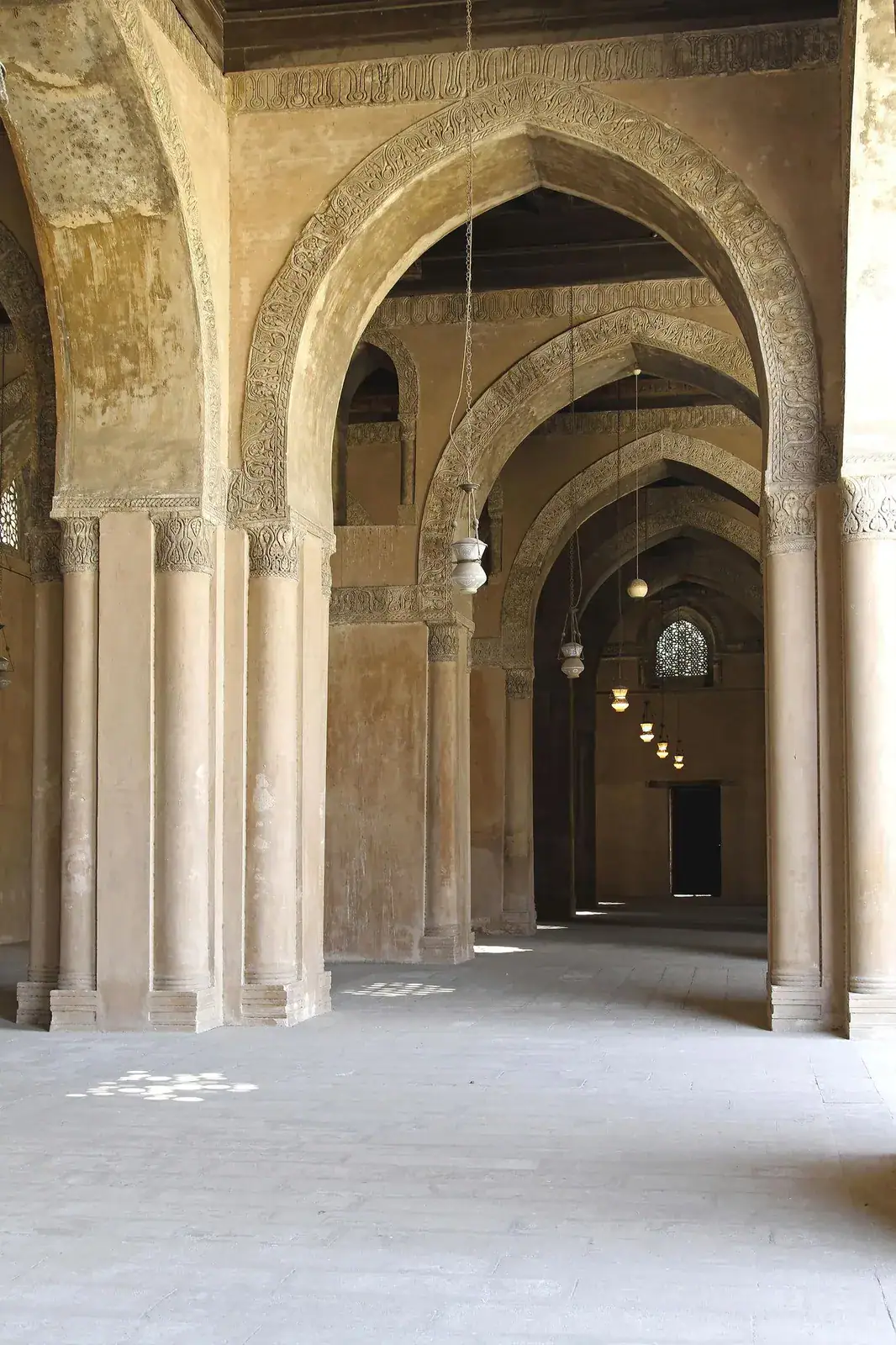 Pointed arches and brick architecture inside an early Islamic mosque