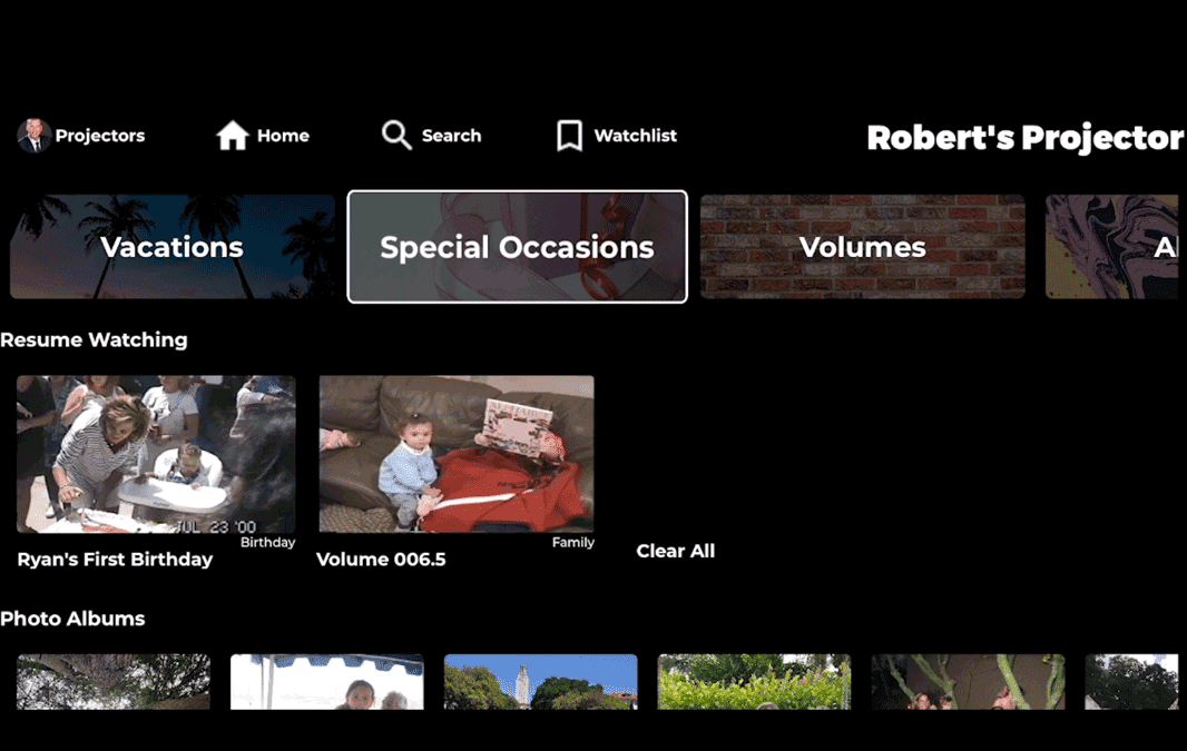 A digital media interface showing various tabs like Vacations, Special Occasions, and Volumes. Below are sections for Resume Watching with videos titled Ryans First Birthday, Volume 006.5, and photo albums. The background is dark.