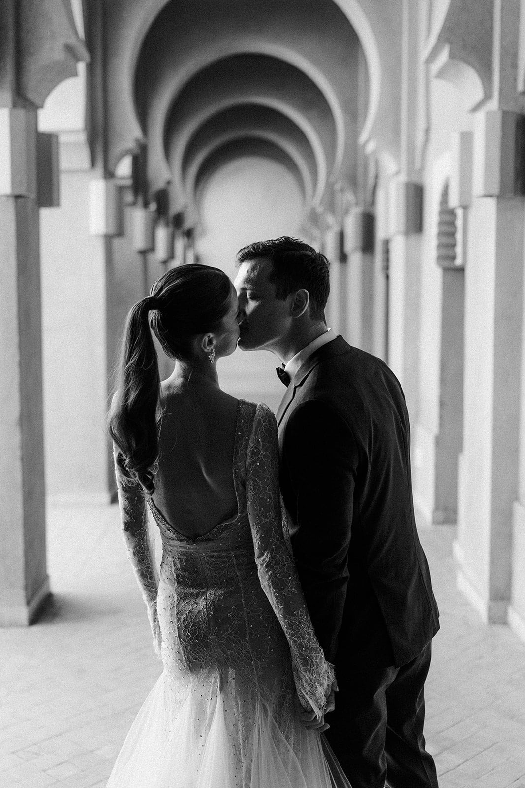 Andrea Gallucci - Destination Wedding Photographer- Amalfi Coast Positano Santorini Barcellona Rome Ravello Paris New York Bride and groom sharing a quiet moment under the arches of Amanjena’s Moroccan resort