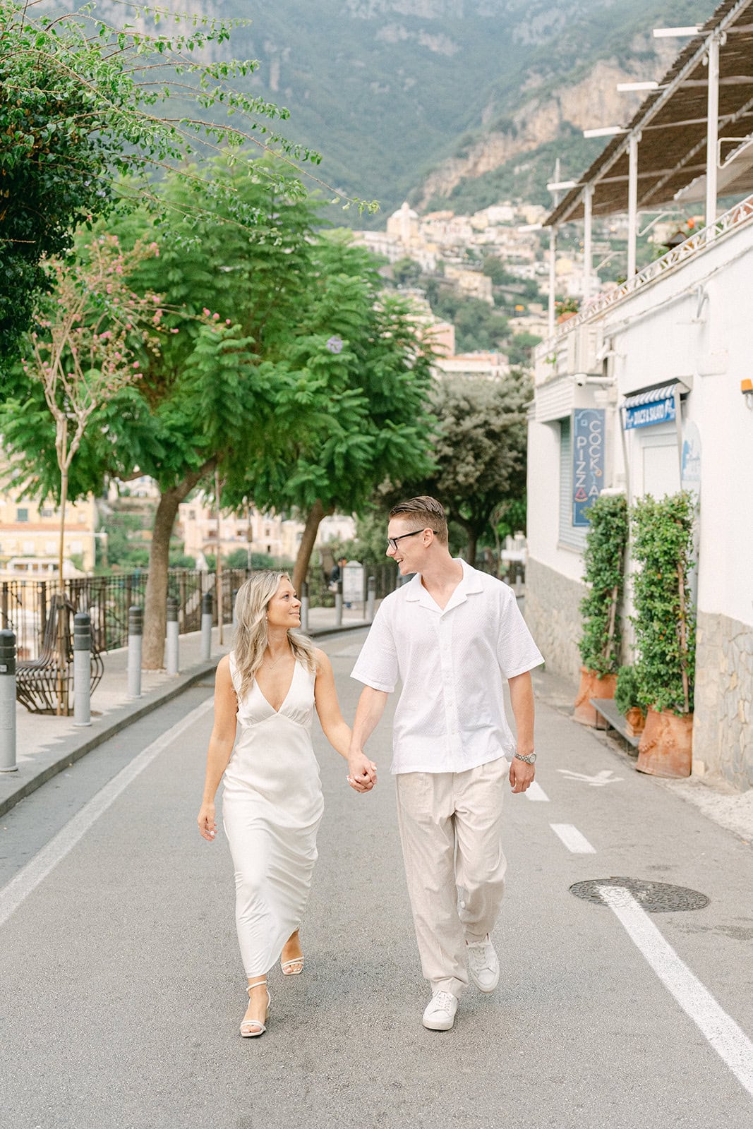 Couple exploring the streets of Positano during their engagement photoshoot